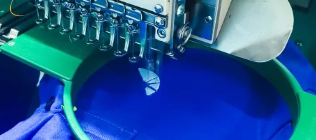 Blue uniform being embroidered on a tajima embroidery machine in Lusaka Zambia