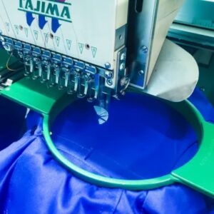 Blue uniform being embroidered on a tajima embroidery machine in Lusaka Zambia