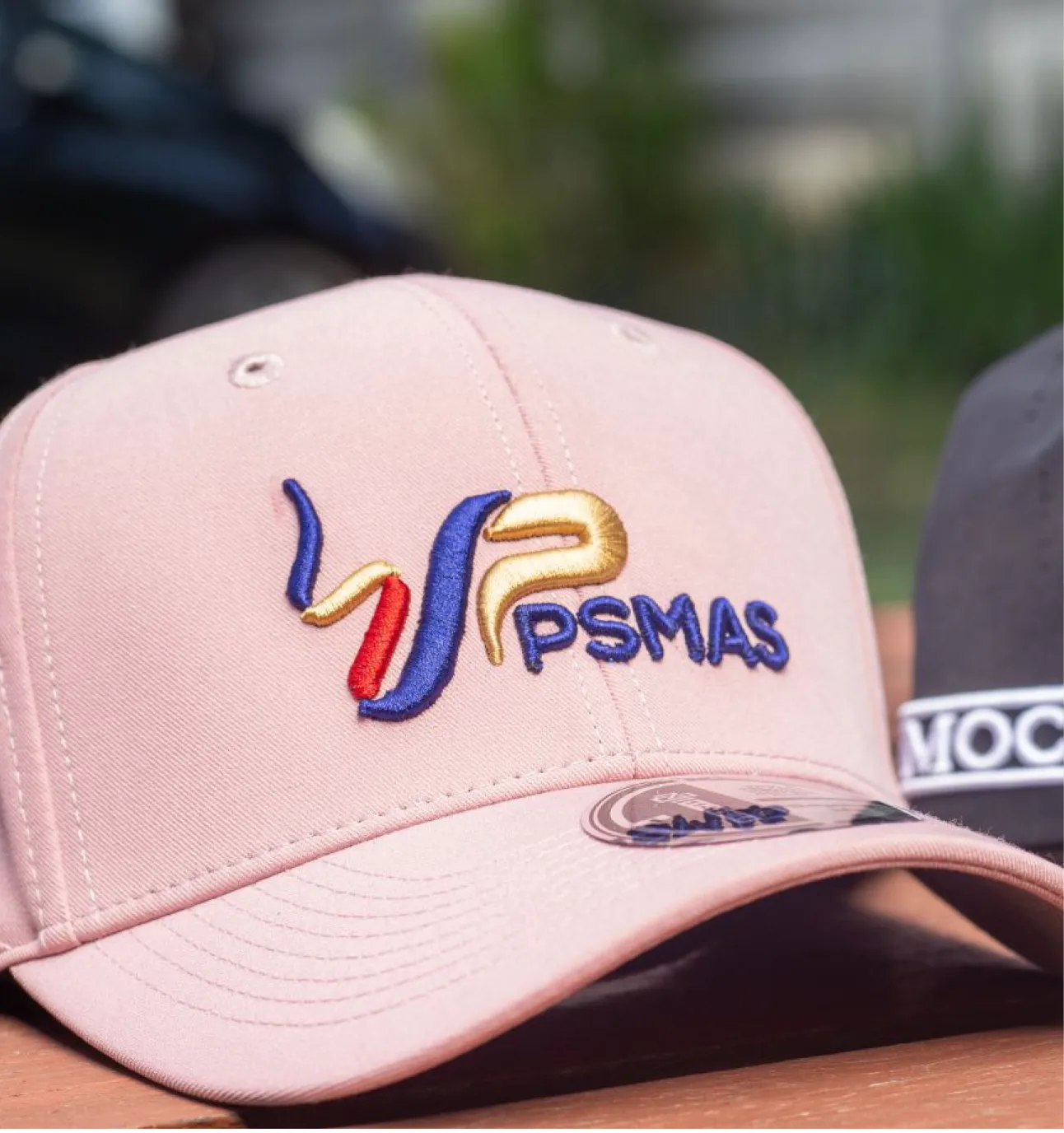 Cap Logo Embroidery Lusaka Zambia pink cap with psmas logo embroidery on the front panel in red blue and gold